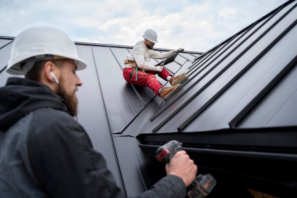 Technicians installing waterproof roof membranes on a commercial building in NYC.