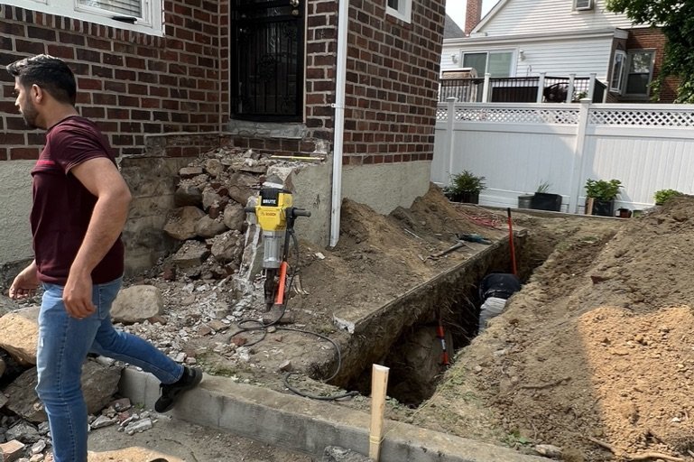 Exterior excavation for foundation drainage at a NYC home to stop basement water